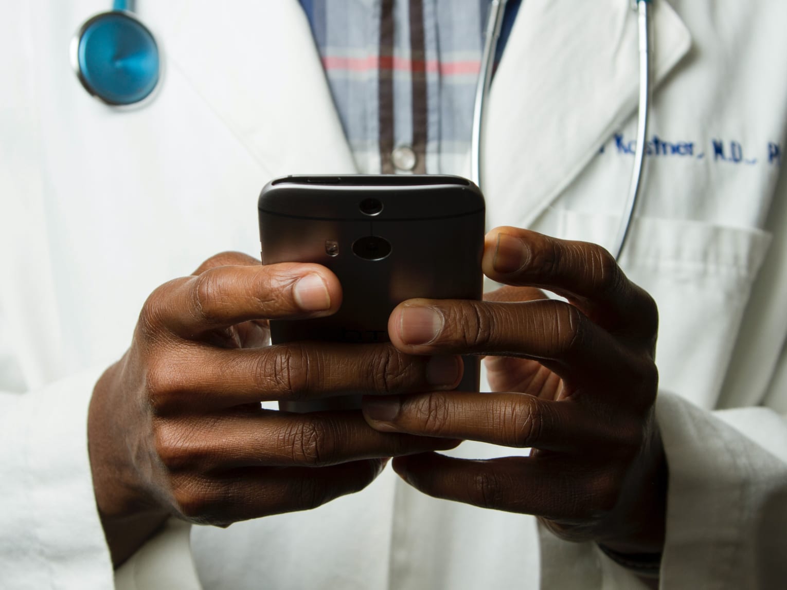 a doctor holding a phone